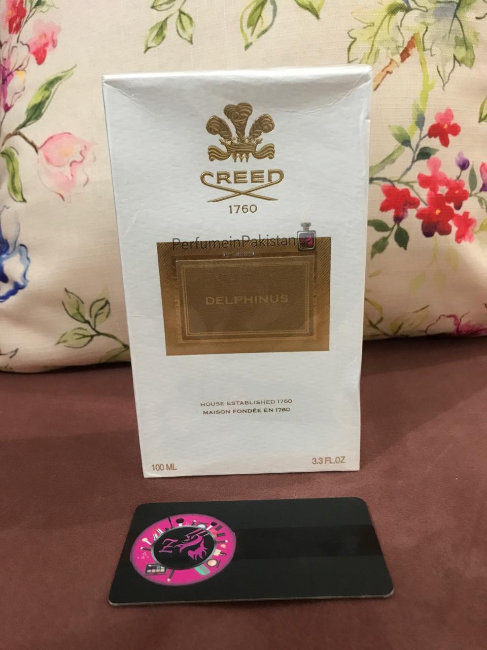Creed Delphinus Eau de Parfum 100ml perfume box displayed with Perfume in Pakistan by Zainab authenticity card on a floral background
