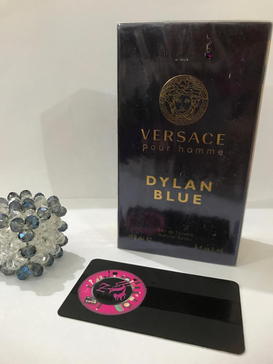 Versace Dylan Blue Pour Homme Eau de Toilette 100ml box displayed with a decorative crystal ornament and Perfume in Pakistan branding.