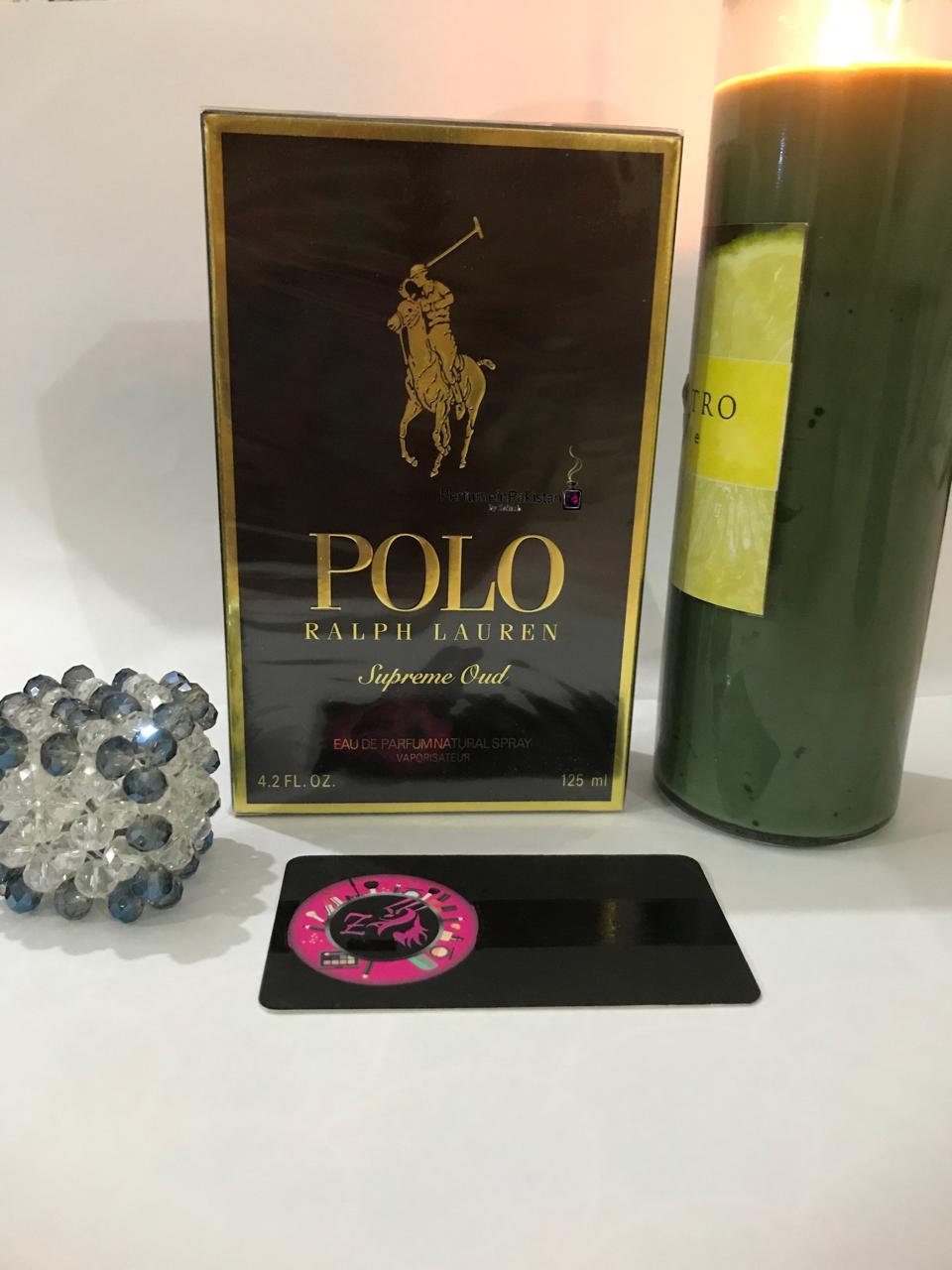 Polo Ralph Lauren Supreme Oud Eau de Parfum 125ml box displayed with a candle and decorative crystal beside it.