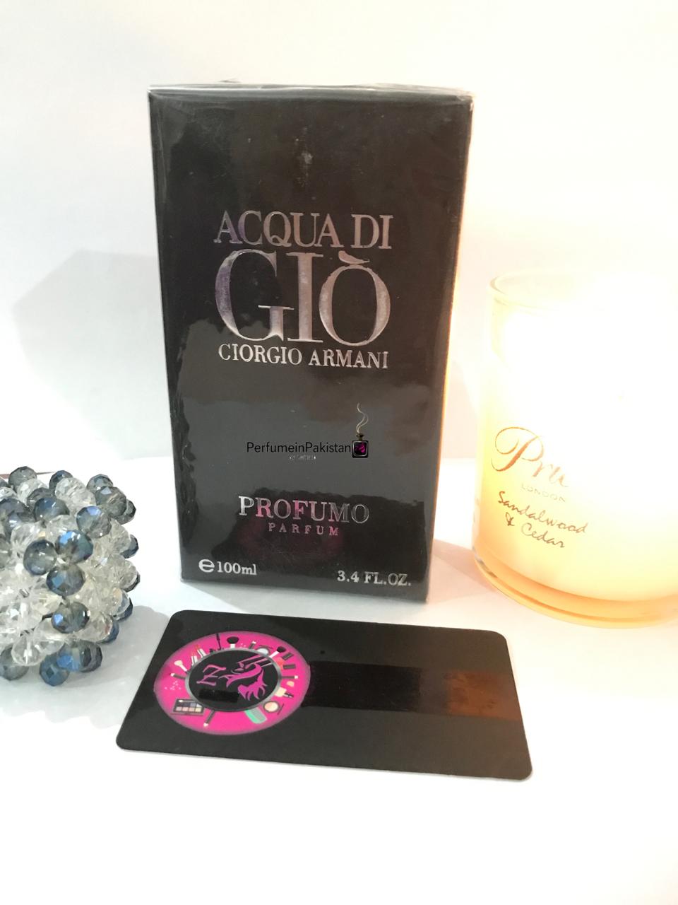 Acqua di Giò Profumo Parfum by Giorgio Armani perfume box displayed with a decorative candle and crystal ornament.