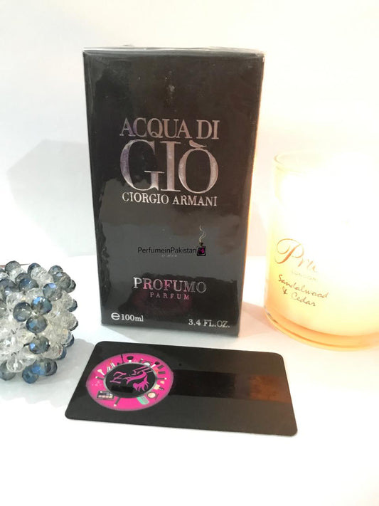 Acqua di Giò Profumo Parfum by Giorgio Armani perfume box displayed with a decorative candle and crystal ornament.