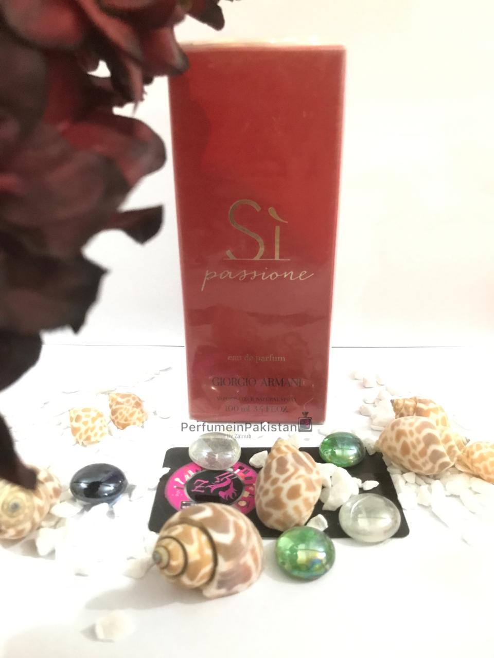 Giorgio Armani Sì Passione Eau de Parfum 100ml women's perfume box displayed with decorative shells and glass stones on a white background | Perfume in Pakistan
