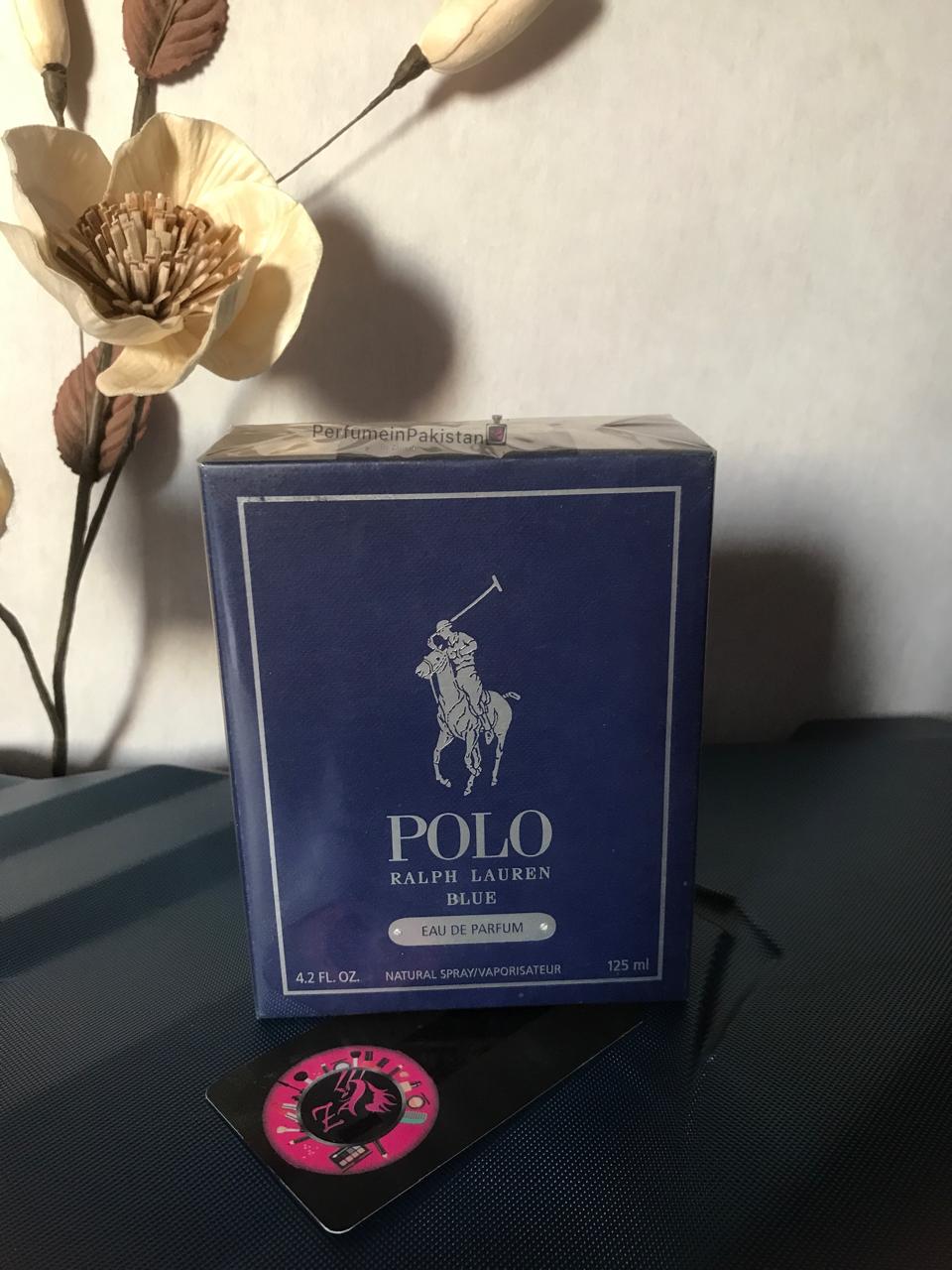 Ralph Lauren Polo Blue Eau de Parfum 125ml men's perfume box displayed with decorative flowers on a dark surface | Perfume in Pakistan