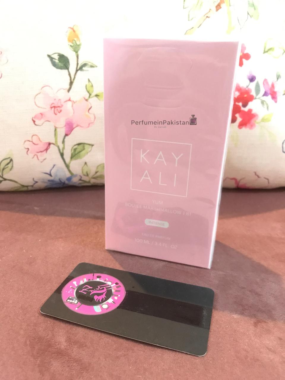 Kayali Yum Boujee Marshmallow 81 Eau de Parfum 100ml women's perfume box displayed on a tabletop with floral background and Perfume in Pakistan branding