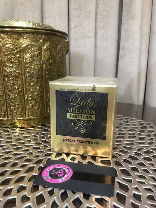 Paco Rabanne Lady Million Fabulous Eau de Parfum Intense 80ml perfume box displayed on decorative gold-patterned table with Perfume in Pakistan branding card