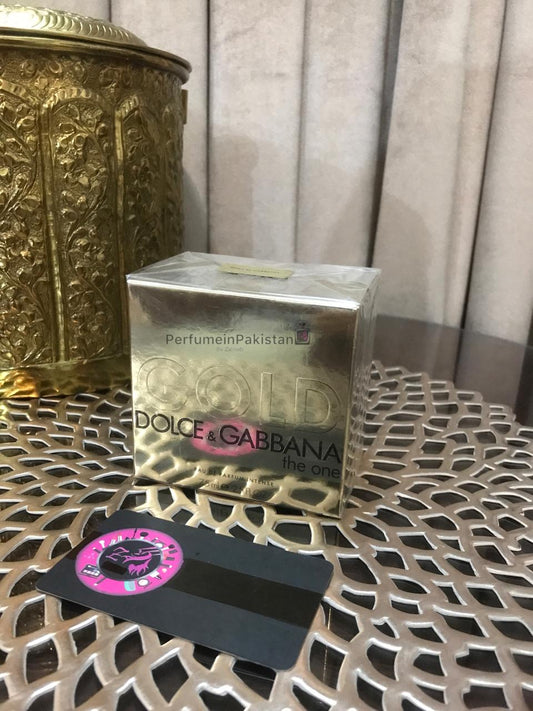 Dolce & Gabbana The One Gold Eau de Parfum Intense perfume box displayed on decorative metallic table with Perfume in Pakistan branding card