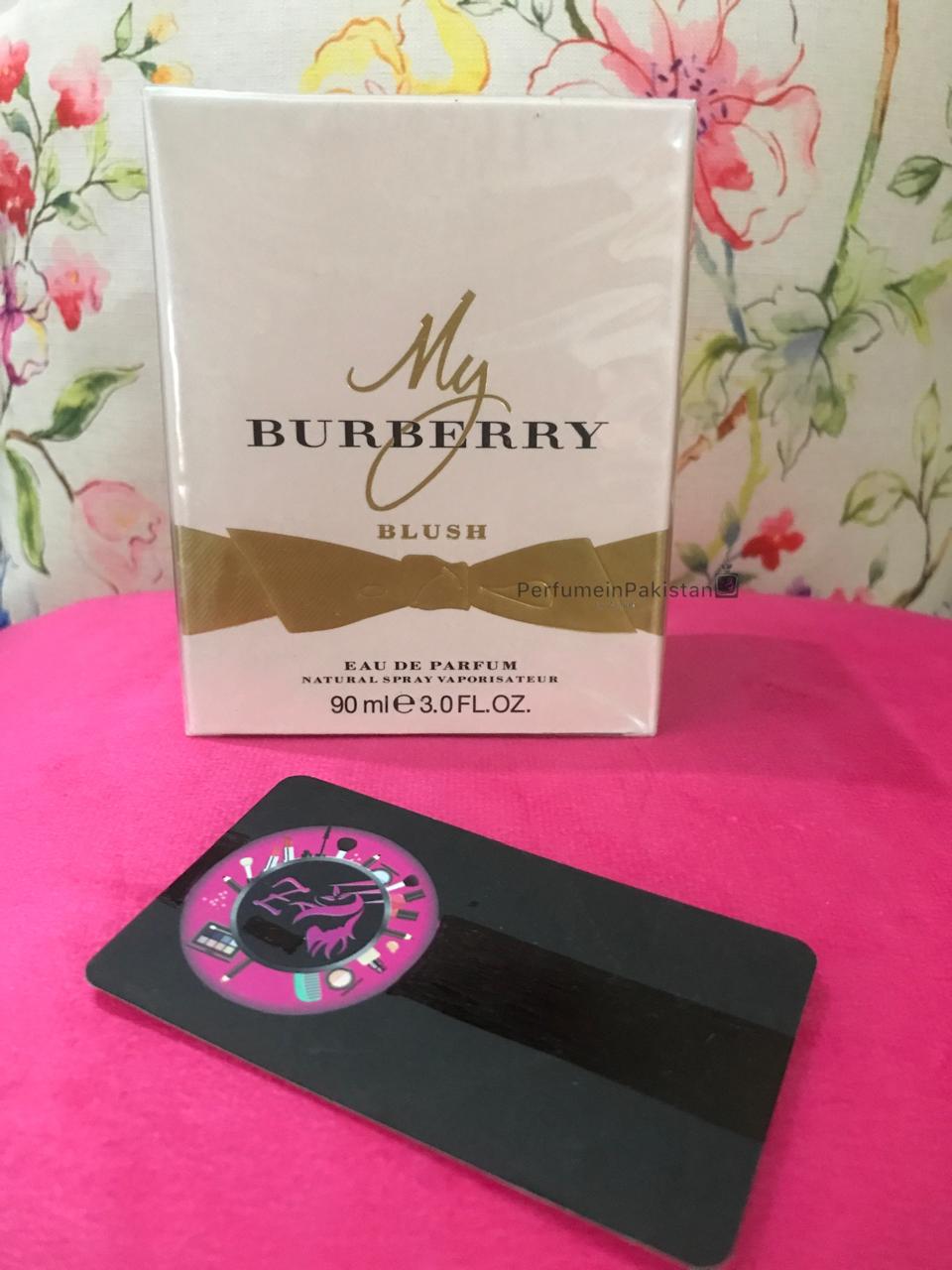 Burberry My Burberry Blush Eau de Parfum 90ml perfume box displayed on a pink velvet surface with floral background and PerfumeinPakistan branding card
