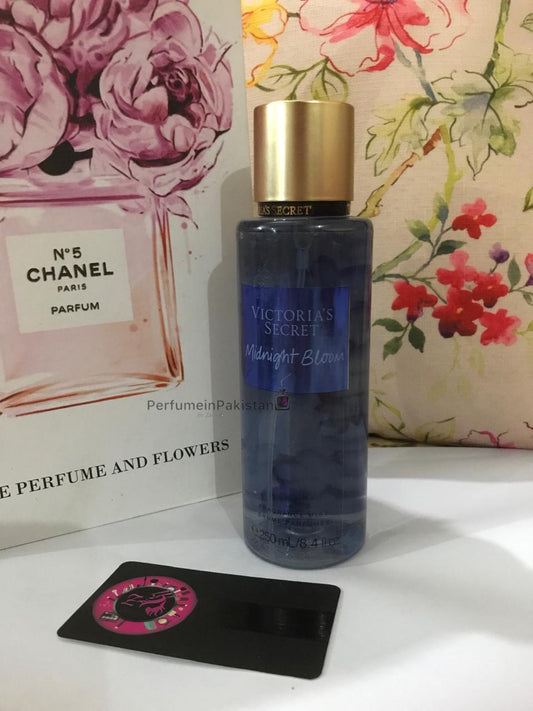 Victoria's Secret Midnight Bloom Fragrance Mist 250ml bottle displayed with floral decor and PerfumeinPakistan branding