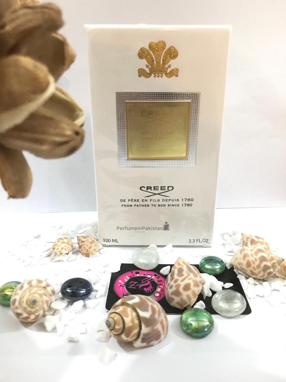 Creed Millésime Impérial Eau de Parfum 100ml perfume box displayed with decorative dried flowers and PerfumeinPakistan branding, featuring elegant white and gold packaging.