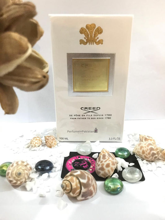 Creed Millésime Impérial Eau de Parfum 100ml perfume box displayed with decorative dried flowers and PerfumeinPakistan branding, featuring elegant white and gold packaging.