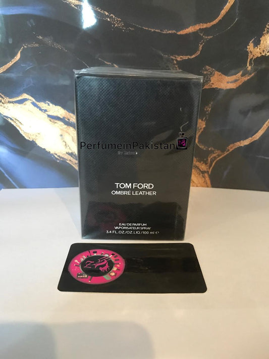Tom Ford Ombre Leather Eau de Parfum 100ml perfume box displayed against a black and gold marble background with PerfumeinPakistan branding card
