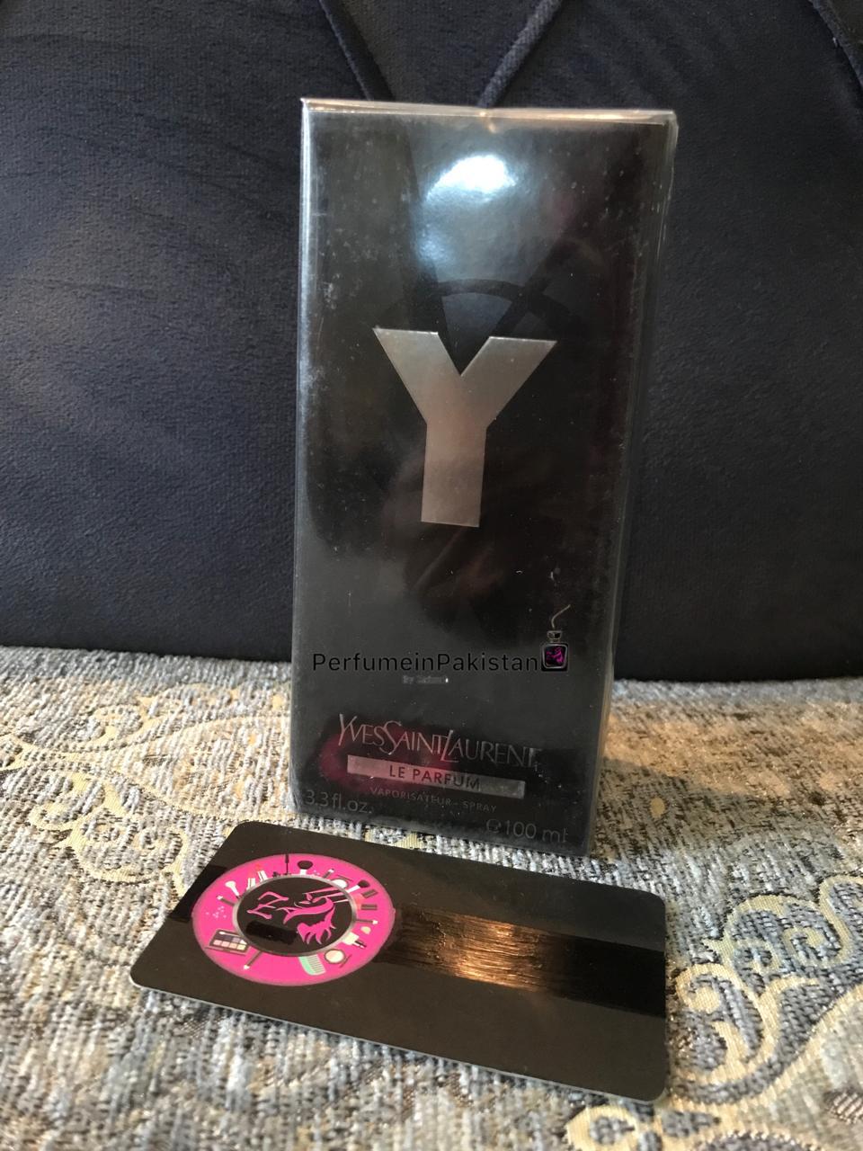 Y Le Parfum by Yves Saint Laurent Eau de Parfum for men in 100ml packaging displayed on a patterned sofa with PerfumeinPakistan branding card.