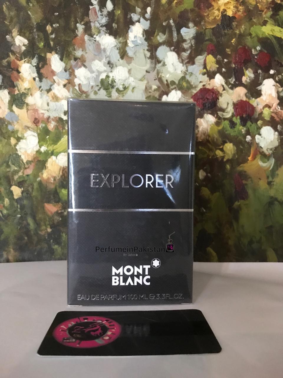 Mont Blanc Explorer Eau de Parfum 100ml perfume box displayed against an artistic floral background with PerfumeinPakistan branding.